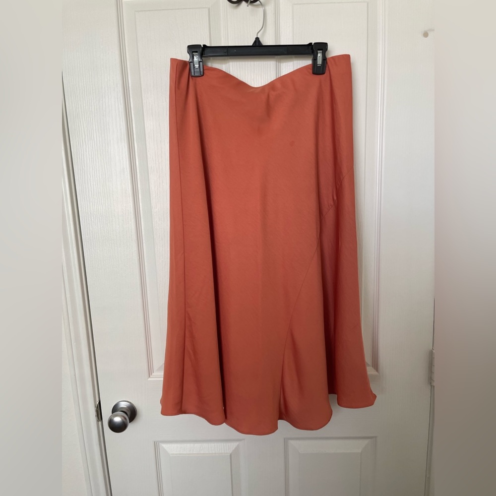 Shin length skirt with elastic waist band. Flowy, silky, very flattering